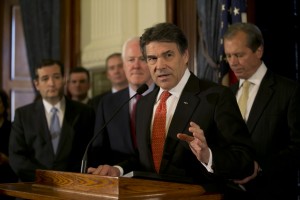 Texas Gov. Rick Perry, flanked by fellow Republican Senators John Cornyn and Ted Cruz, blasts Medicaid expansion in Texas