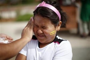 Fernanda Garcia-Villanueva, 8, has sunscreen applied before the annual run/walk for patients and their friends and families at The Children's Hospital in Aurora