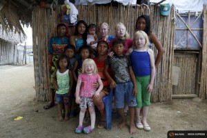 Four albino sisters, from L-R, Iveily, Donilcia, Jade and Yaisseth Morales, who are part of the albino or "Children of the Moon" group in the Guna Yala indigenous community, pose for a photograph with their mother, brothers and sisters outside their house on Ustupu Island in the Guna Yala region, Panama April 24, 2015. REUTERS/Carlos Jasso