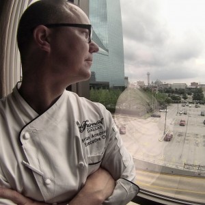 Chef Brian of the Pyramid restaurant in Dallas' Fairmont Hotel surveys the skyline on his way to his rooftop garden.