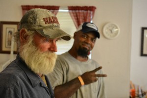 Two men stand in line for food at Southside Community Shelter. Photo by Jesse Louden/VoiceBox Media